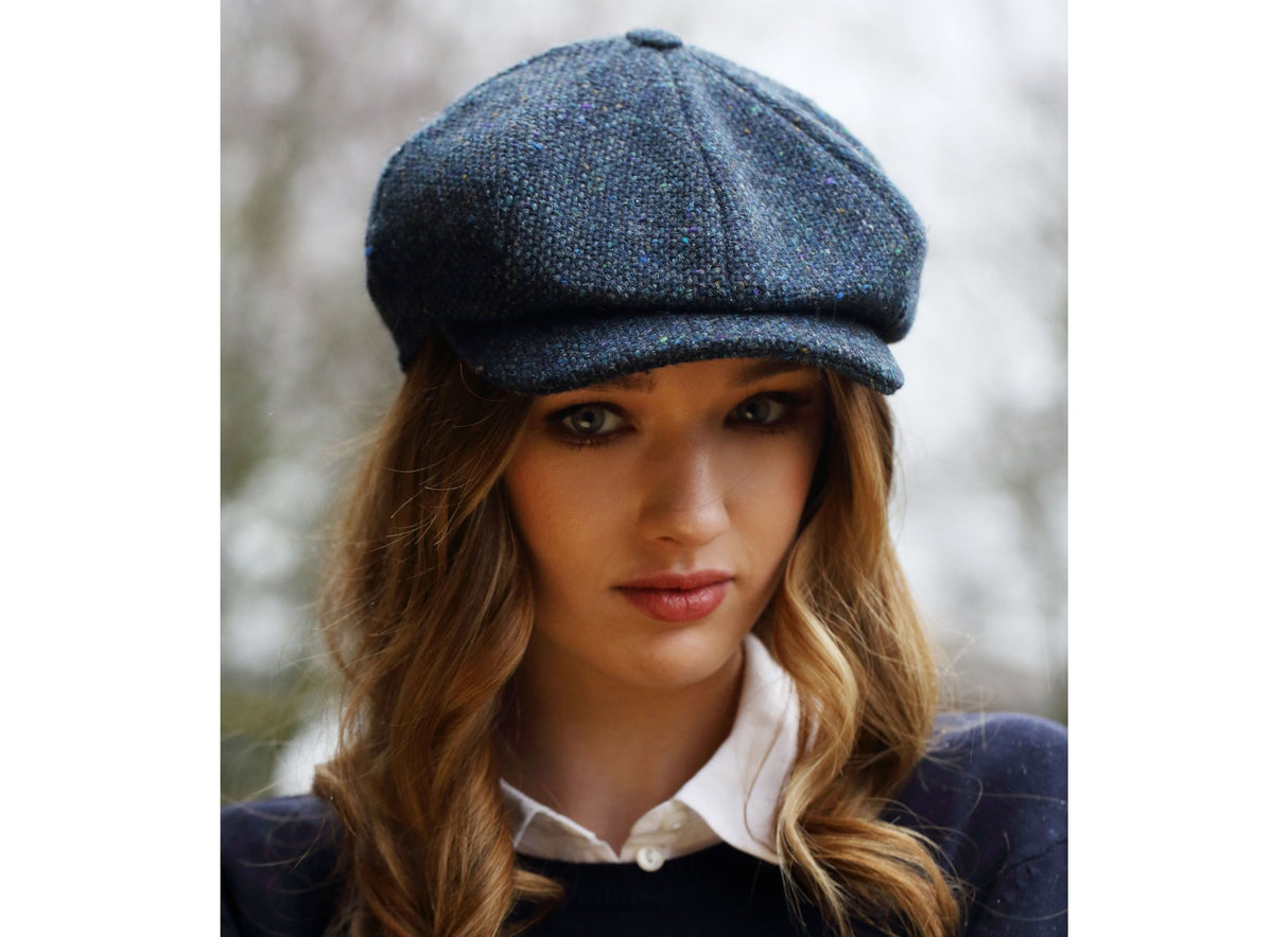 woman wearing a Navy and Aqua Donegal Tweed Peaky Blinders Style Cap by Hanna Hats of Donegal.