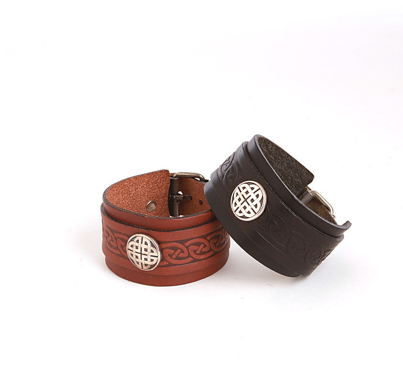 Black and brown leather wrist cuffs with pewter conch and buckle fasteners by Lee River Leather