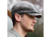 Man wearing Grey Donegal Tweed Peaky Blinders Style Cap by Hanna Hats of Donegal.