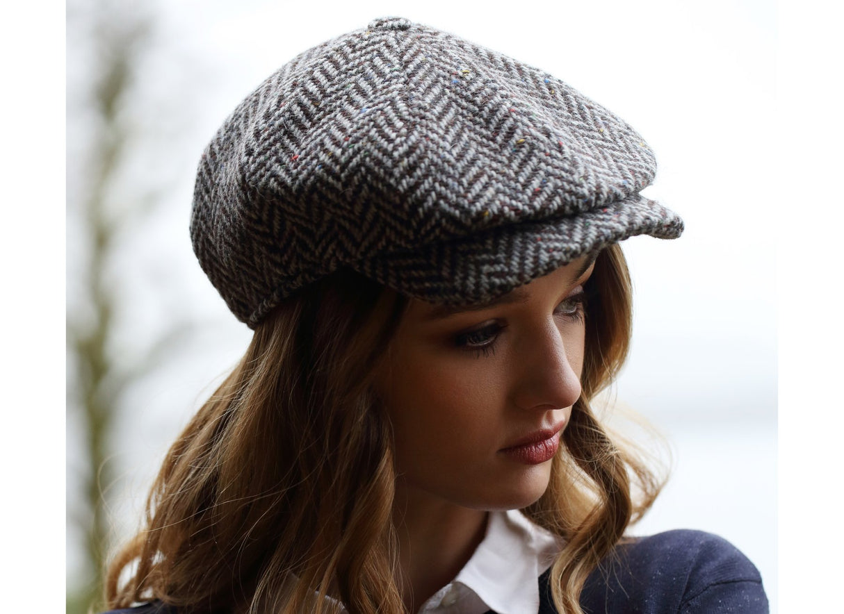 woman wearing a Black and Grey wide Herringbone Donegal Tweed Peaky Blinders Style Cap by Hanna Hats of Donegal.
