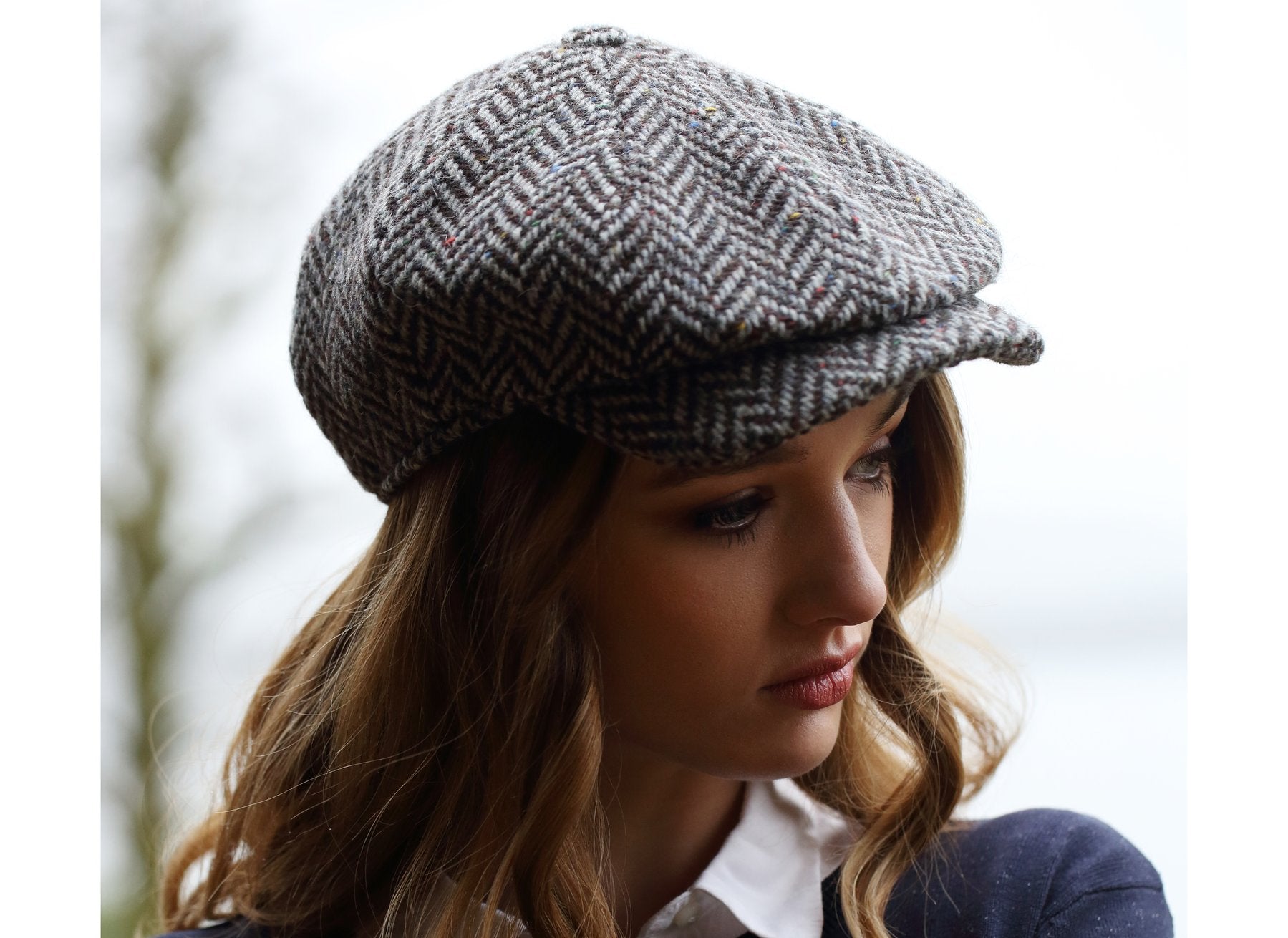 woman wearing a Black and Grey wide Herringbone Donegal Tweed Peaky Blinders Style Cap by Hanna Hats of Donegal.