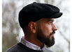 man wearing a Solid black color Peaky Blinders style cap by Hanna Hats of Donegal