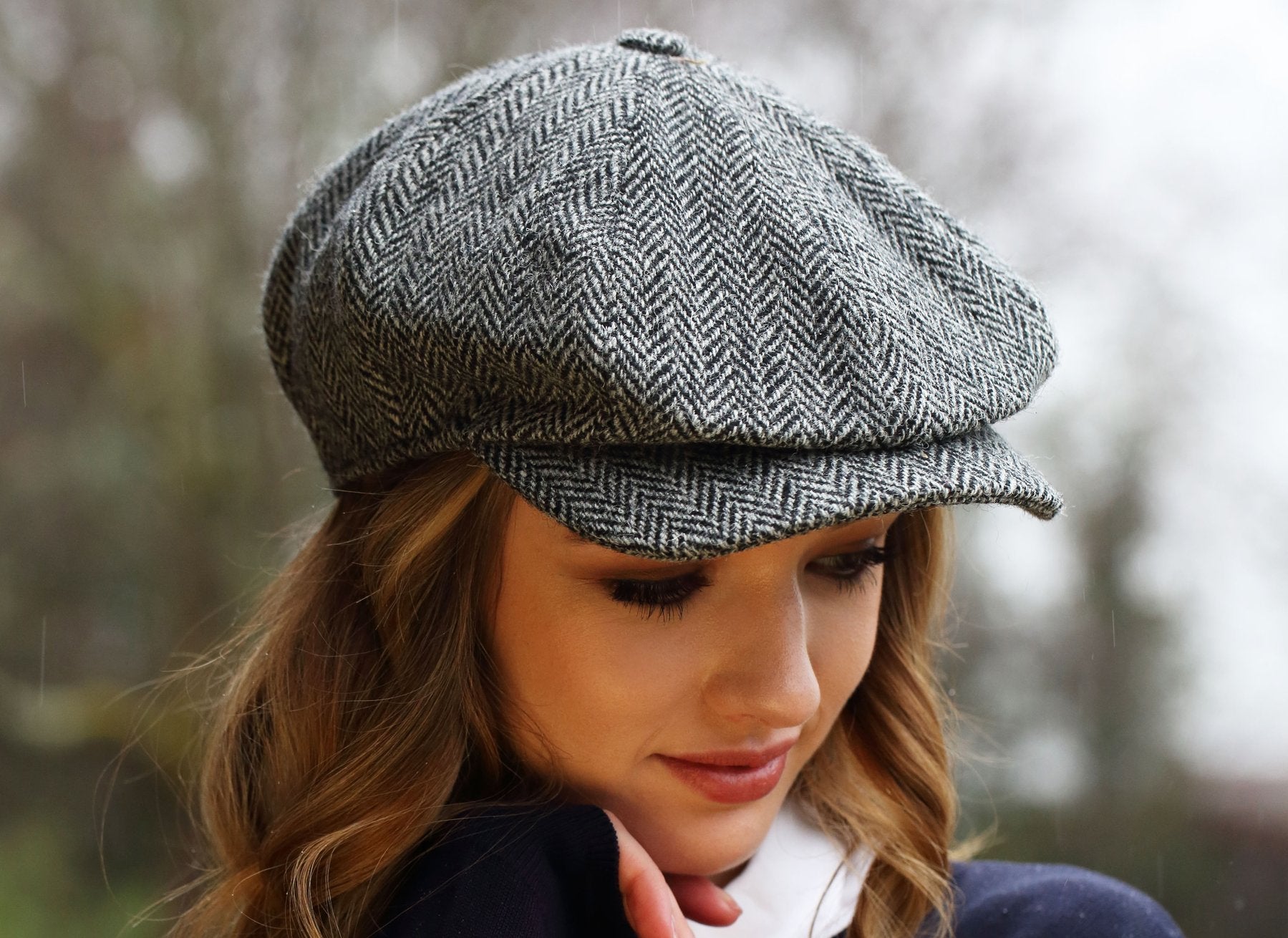 woman wearing a Classic black and white herringbone Peaky Blinders style cap by Hanna Hats of Donegal