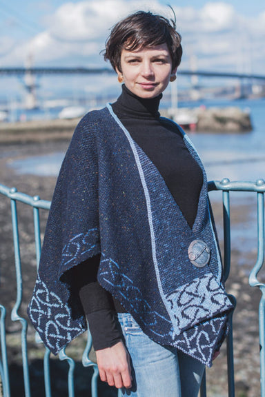Front image of Woman wearing a blue color Celtic Stole with red bridge and river in background, by Bill baber clothing of Scotland. Available at www.realirish.com in the USA